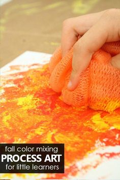 a person is painting with orange and yellow colors on the paper that says fall color mixing process art for little learners