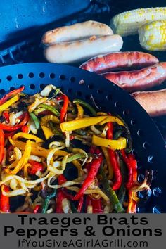 grilled brats, peppers and onions on the grill with corn in the background