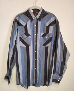 Vintage Western Fashions black & blue striped shirt, pearl button front, 3 snap pearl button sleeves, no size fits like a large. *Vintage Clothing & Linen Disclaimer- Please understand that our vintage linens and clothing are pre-owned. While we wish we could take the time to wash every single piece that's just impossible with a large inventory & so many different fabrics. While we do our best to ensure no odors are present there may sometimes be smoke odors as many of our items are from an era Vintage Western Fashion, Blue Striped Shirt, Vintage Western, Western Shirts, Single Piece, Different Fabrics, Vintage Linens, Striped Shirt, Western Fashion