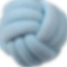 a blue ball of yarn is shown on a white background with the image blurry