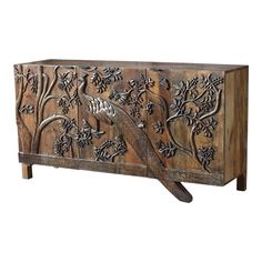 an old wooden cabinet with carvings on the doors and drawers, decorated with flowers and birds