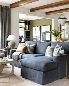 a living room filled with lots of furniture and decor on top of carpeted flooring