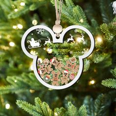 a mickey mouse ornament hanging from a christmas tree