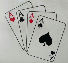 four playing cards are shown on a white background with red and black hearts in the middle