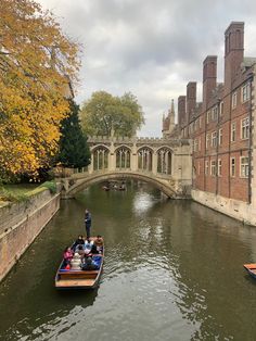 people are riding in a boat down the river