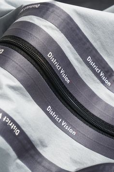 the zippers on this bag are labeled with names