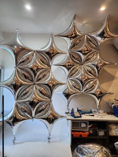 a room filled with lots of shiny mirrors and silver objects on top of a table