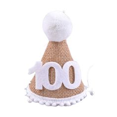 a hat with the number 100 on it and pom - poms around the top