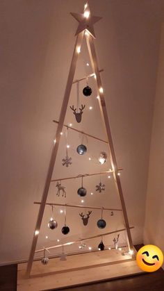 a wooden christmas tree with lights on it