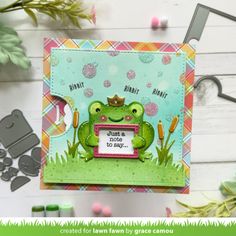 a card with a frog holding a sign