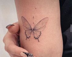 a woman's thigh with a butterfly tattoo on it