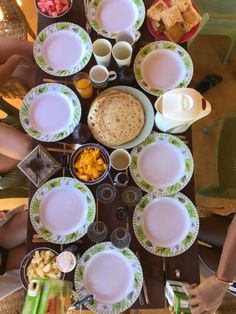 a table full of plates and bowls with food on them