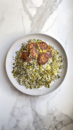 a white bowl filled with food on top of a marble counter