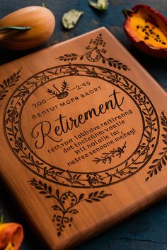 a wooden plaque with the words retirement engraved on it, surrounded by flowers and leaves