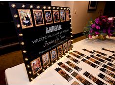 a table topped with lots of pictures and flowers