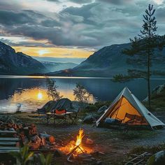 a tent is set up next to a campfire