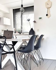 a dining room table with chairs and laptops on it