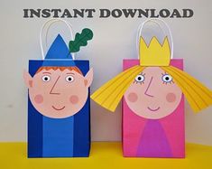 two paper bag puppets with faces on them