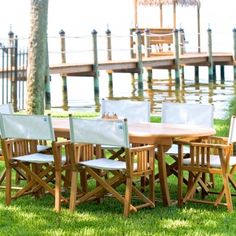 a wooden table and chairs sitting in the grass