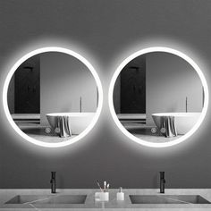 two round mirrors are shown in front of a sink and mirror with lights on it