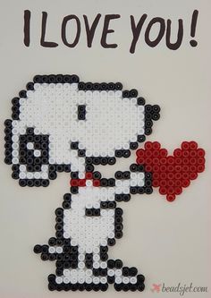 a beaded greeting card with a snoopy dog holding a red heart and the words i love you written on it