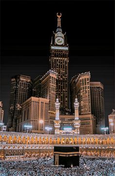 a large group of people standing in front of a building with a clock on it