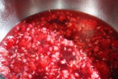 a pot filled with red liquid sitting on top of a stove