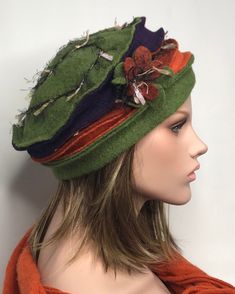 This boiled wool winter hat will be the ideal finish to your outfit. The hat is colored green, purple, orange and brick. On the side of the hat a flower worked in wool, the background is embroidered in matching color wool. Available in several colors and in two sizes for the head circumference 53-57 and 58-60cm stretchable, covers the ears well. Pleasant, soft and warm. Without the lining. It is possible to coordinate it with mittens and scarf. Dry clean or by hand in cold water. Green Winter Hat, Country Hats, Funky Hats, Woman Hat, Hat Fits, Wool Caps, Unique Hats, Dress Bohemian, Wool Winter