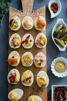 an overhead view of small appetizers on a wooden board