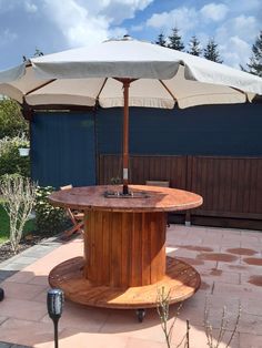 an umbrella is on top of a wooden table