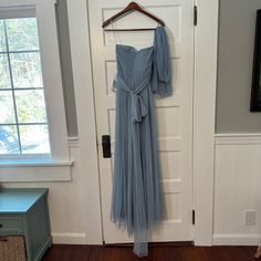 a dress hanging up on a door