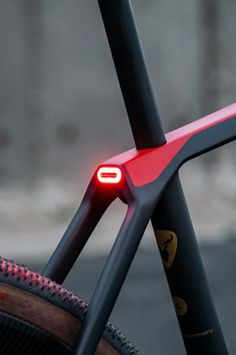 a close up of the front end of a bike with red lights on it's spokes