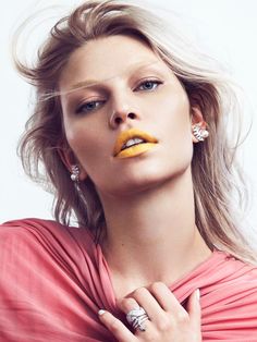 a woman with yellow lipstick on her lips