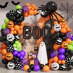 a halloween wreath with balloons and decorations in the shape of boos, bats, and pumpkins