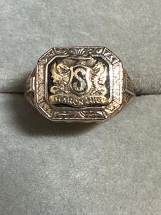 "A very vintage, almost antique 10K yellow gold class ring.  The ring is hallmarked 10k and guaranteed to be such. It also has script initials \"LKH\" and is marked Heron High School. I believe the it is actually \"Sharon\" as there is also an \"S\" in the middle of the crest.  Aside from the S and last H from  \"High\" missing due to wear, this piece is in fabulous shape. It will officially graduate to \"antique\" in 2028.  Its art deco styling is magnificent with fabulous detailing. The crest Vintage Hallmarked Engraved Ring For Formal Occasions, Antique Engraved Ring With Hallmarks For Formal Occasions, Vintage Signet Ring For Anniversary, 14k Gold Engraved Ring With Initials For Collectors, Vintage 14k Rings For Commemoration, Heirloom Engraved Ring For Commemoration With Hallmarks, Vintage Silver Signet Ring In 14k Gold, Antique 14k Stamped Initial Ring For Anniversary, Antique Engraved Ring With Maker's Mark For Anniversary