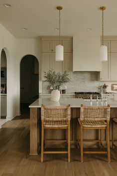 a kitchen with two chairs and an island