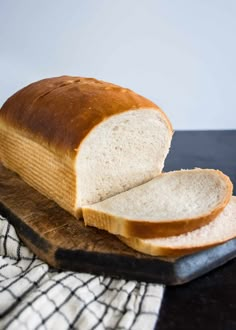 a loaf of bread sitting on top of a cutting board