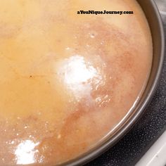 a pan filled with food sitting on top of a stove