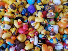 many small rubber ducks are grouped together in this pile, all different colors and sizes