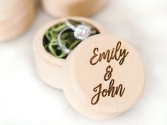 two wedding rings in a wooden box with the word'enjoy and john'engraved on it