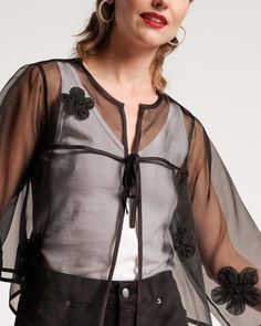 Indulge in the ethereal and dreamy organza Parker Swing Jacket. The weightless top boasts a delicate sheer construction and scattered floral appliques that will add grace to any look. Lightweight sheer mesh women's swing jacket Featuring scattered floral appliques Full-length sleeves with one front tie Material: 100% Polyester Made in India