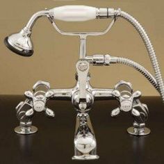 an old fashioned shower faucet with two handset and three hoses attached to it