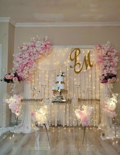 a cake table with flowers and lights on it