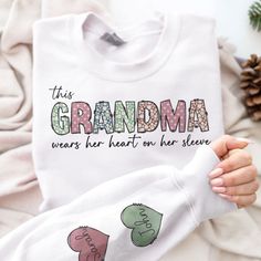 Give Mom, Aunt or Grandma a wardrobe refresh with our Personalized Sweatshirt! Personalize this sweatshirt with your choice of heart color, title and names that are printed on the sleeves of the sweatshirt. A heartwarming gift she'll always treasure and she'll love wearing!Our custom sweatshirt makes for great gifts on any occasion, such as birthday gifts, Christmas Eve, Thanksgiving gifts. Let’s make a one-of-a-kind gift for the important women in your life. MESSAGE: This Mama/Aunt/Grandma wear her heart on her sleeve. PRODUCT DETAILS: 100% cotton (99% for ash/grey colors, 50% for hoodie) Decoration type: Digital Print 3d Sweater, Wardrobe Refresh, Laundry Guide, Leather Passport Cover, Apparel Brand, Custom Sweatshirts, 3d T Shirts, Heart On, Thanksgiving Gifts