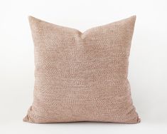 a beige pillow on a white background