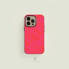 an iphone case with pink and red zebra print on the front, sitting on a white surface