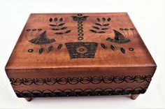 a wooden box with decorative designs on it