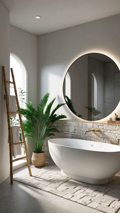 a large white bath tub sitting under a round mirror next to a ladder and potted plant