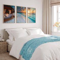 two paintings on the wall above a bed in a bedroom with white sheets and pillows