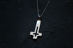 Upside down cross with a hollowed out design. Made in very shiny stainless steel. Comes with chain! Ships worldwide from Sweden! © 2020 Torvenius Illustration ABModel is Christina Zelmerlöw feathersandflesh_@instagram Handmade Stainless Steel Cross Jewelry, Handmade Stainless Steel Cross Pendant Jewelry, Handmade Stainless Steel Cross Pendant Necklace, Handmade Stainless Steel Cross Pendant, Handmade Stainless Steel Cross Necklace, Upside Down Cross, Pin Button Badges, Coin Set, Hollow Design